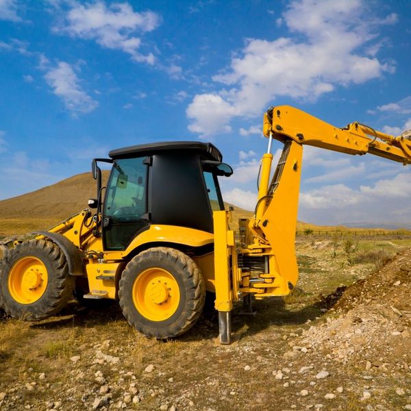 Yellow excavator digging