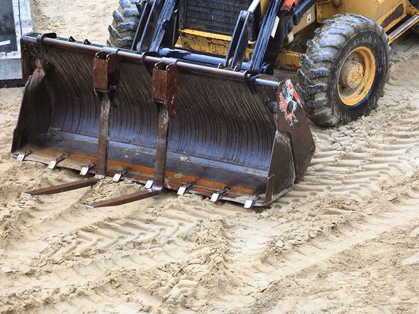 Old bulldozer on sandy area