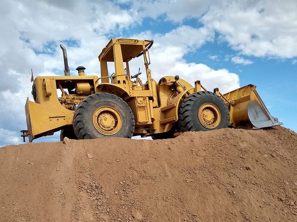 Bulldozer sitting on a hill of dirt