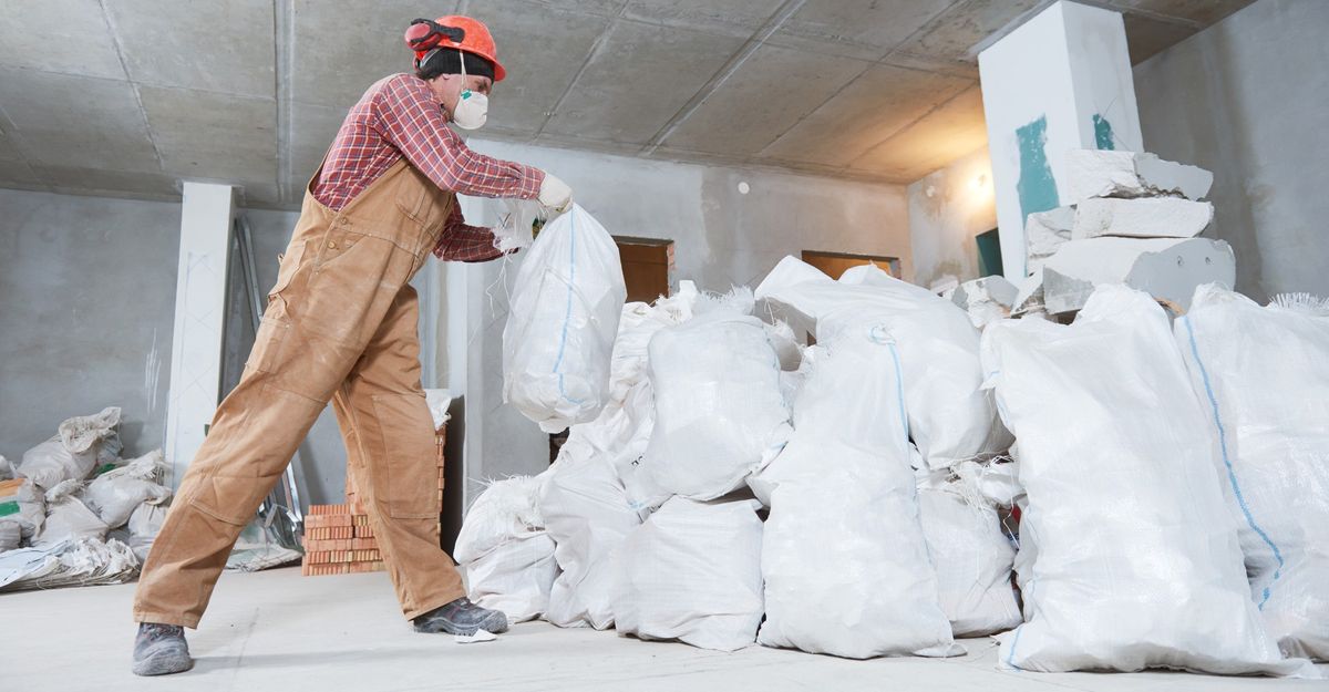 construction worker piles trash