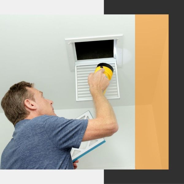 technician inspecting duct