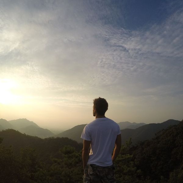a man staring off at a mountain landscape