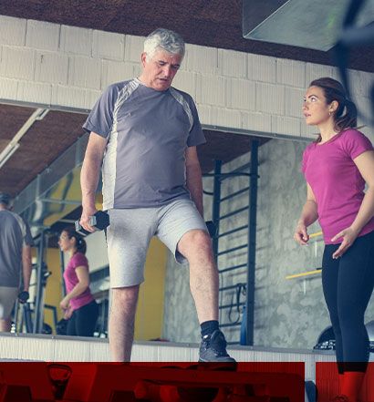 Older man working out with trainer