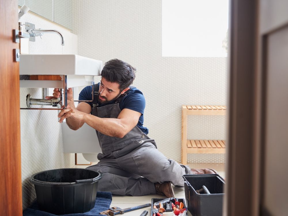 Plumber fixing sink