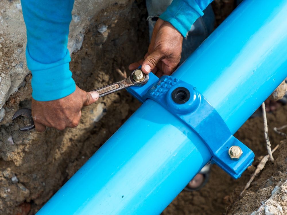 Plumber working on sewer pipe