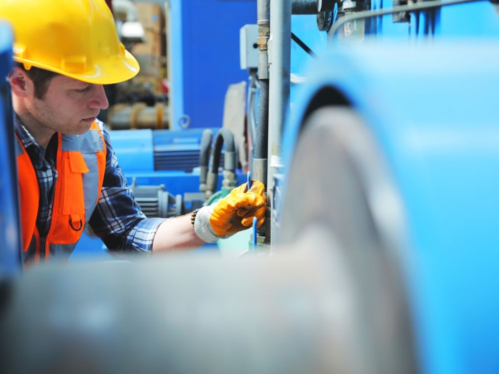  A plumber working on a commercial water pump