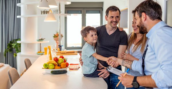 A happy family talking with a plumber