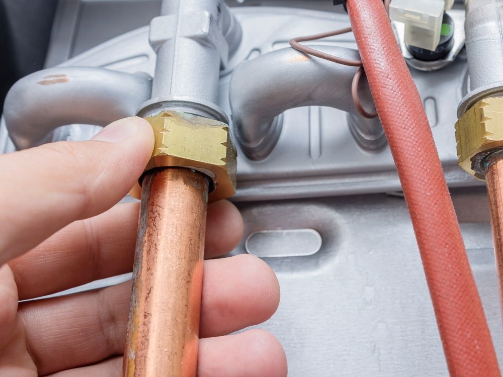 Tightening a bolt on a copper pipe