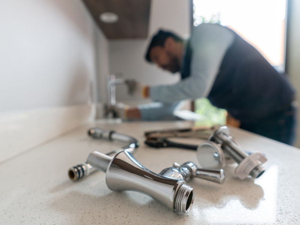 A plumber assembling a faucet