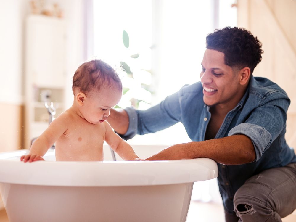 A father and young son during bath time