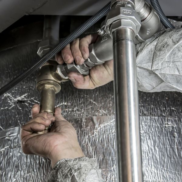 plumber working on pipes