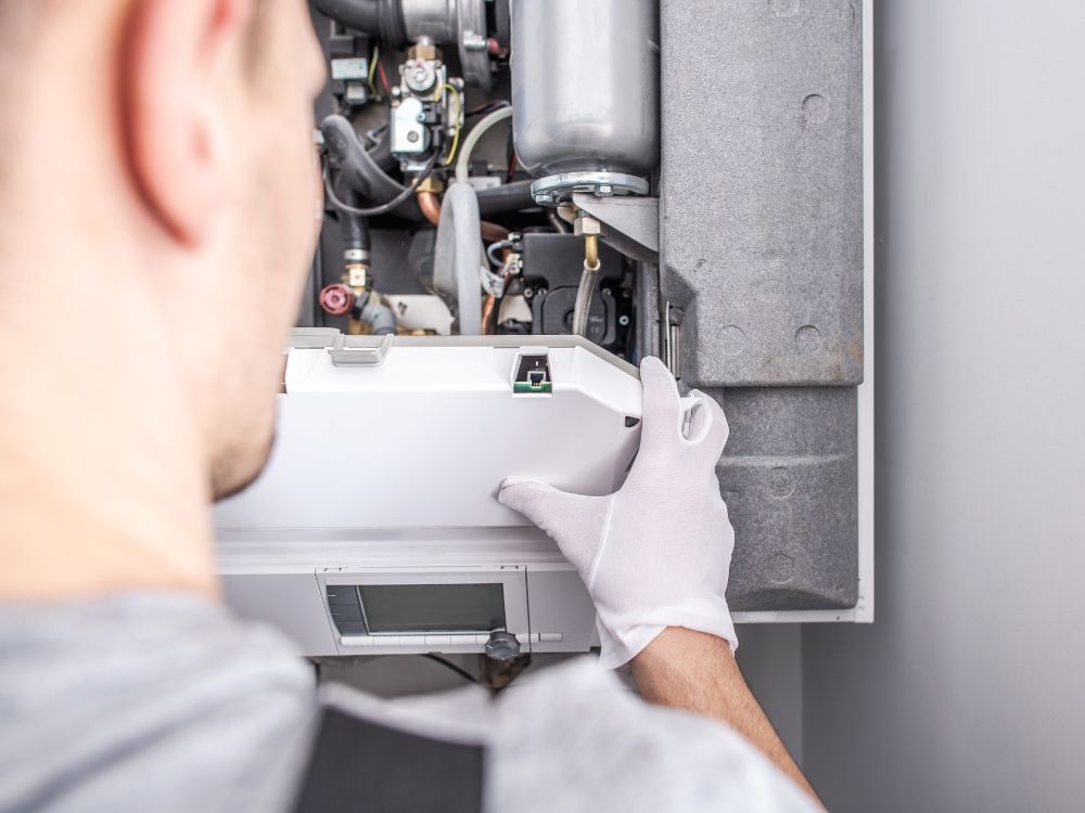 Plumber taking apart water heater