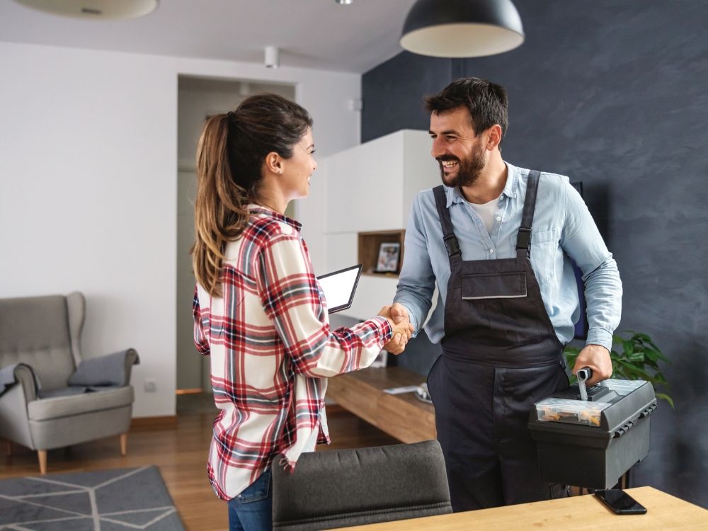 A plumber shaking hands with a client