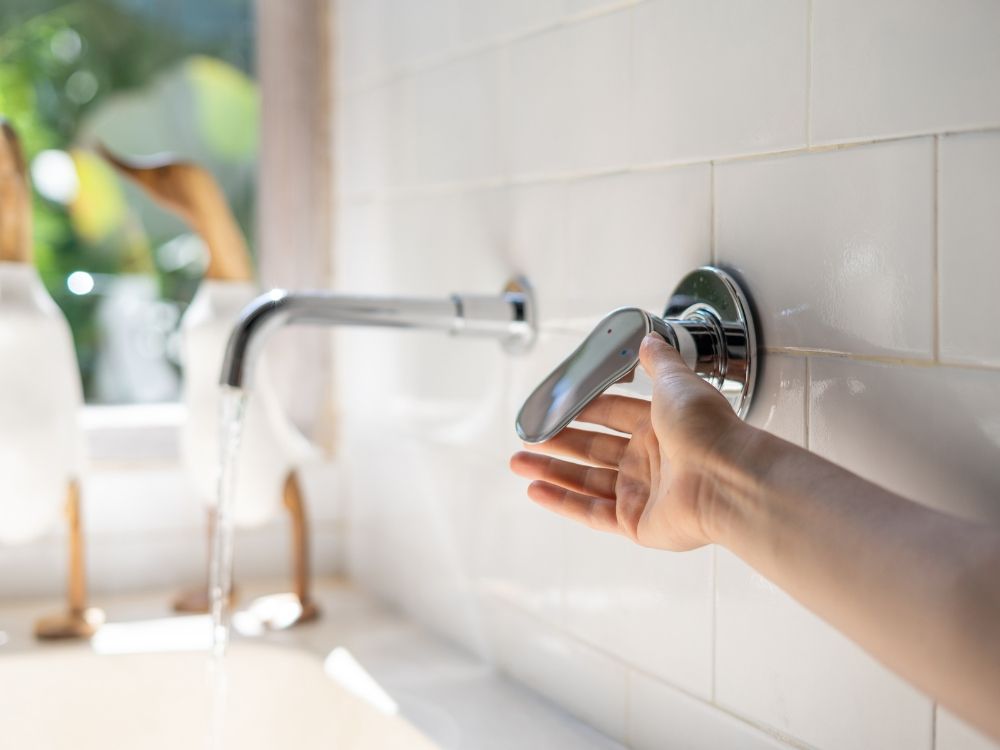 A person filling the tub for a bath