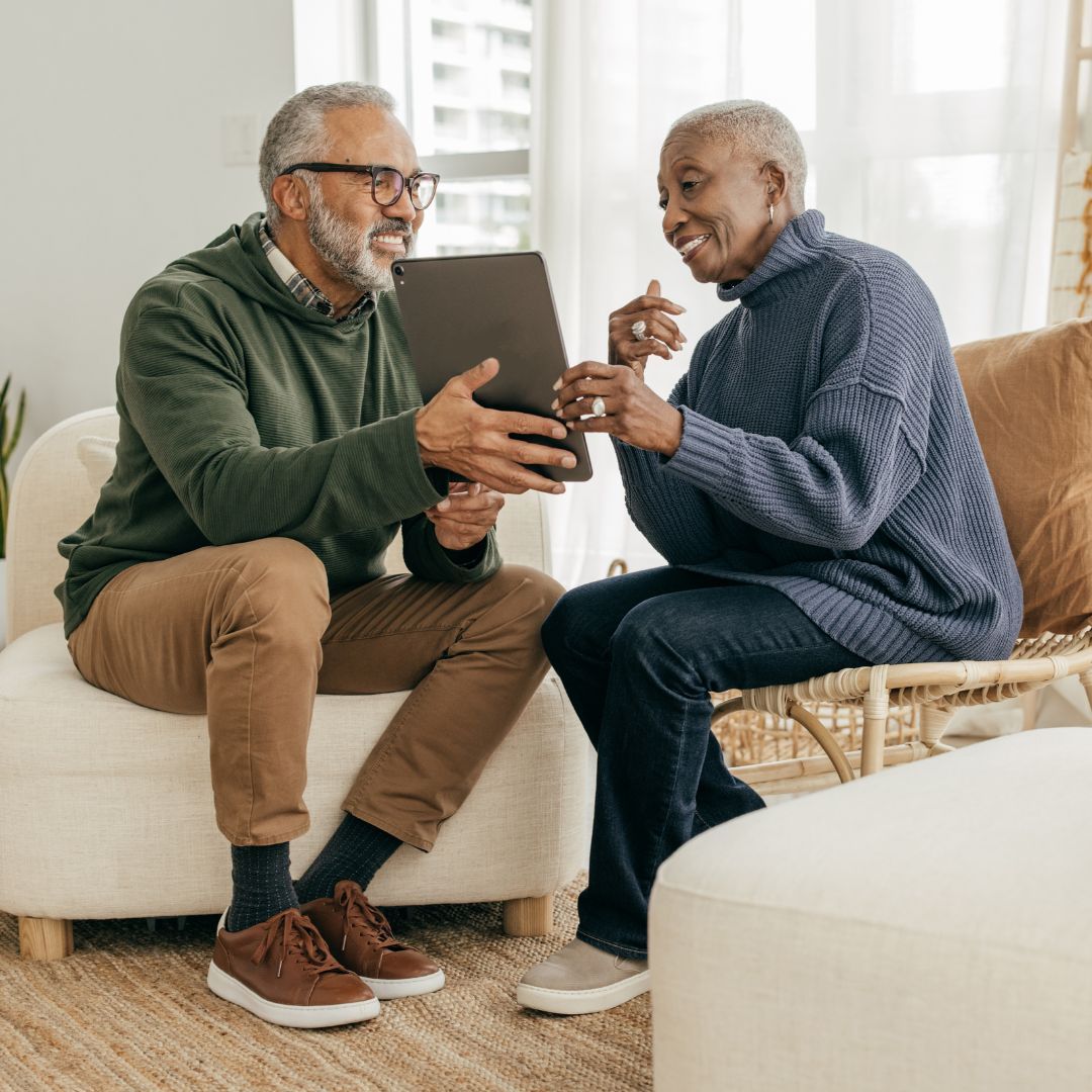 senior couple looking at tablet