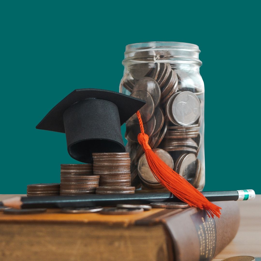 Graduation cap on a stack of coins