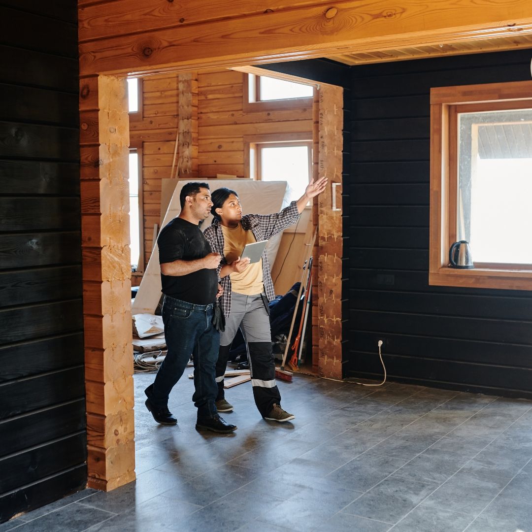 Home remodel contractors walking through a home