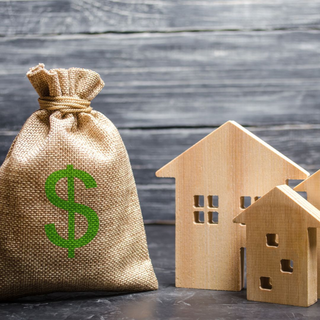 wooden home blocks with a bag of money