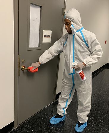 EnviroClean technician applying disinfectant