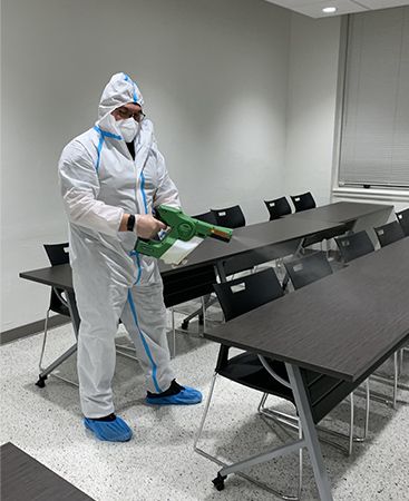 EnviroClean technician using electrostatic sprayer