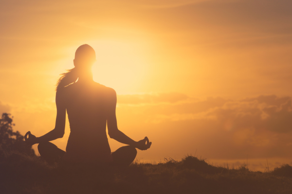 woman looking peaceful while meditating. 