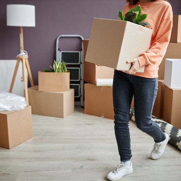 person carrying boxes in new apartment