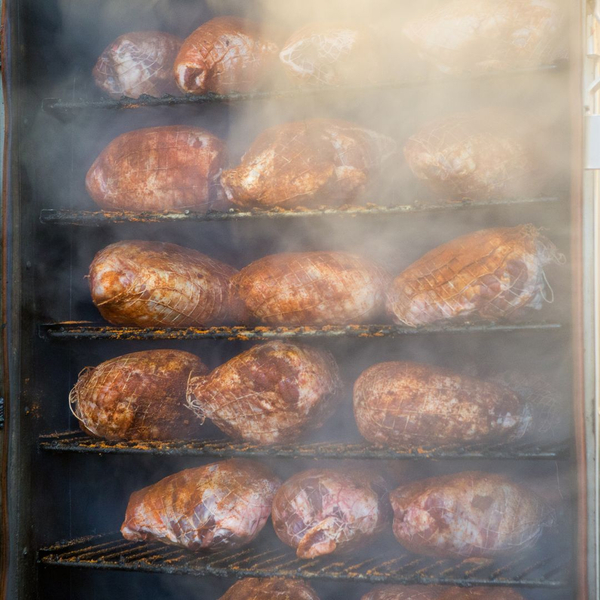 smoke rolling out of a meat smoking oven