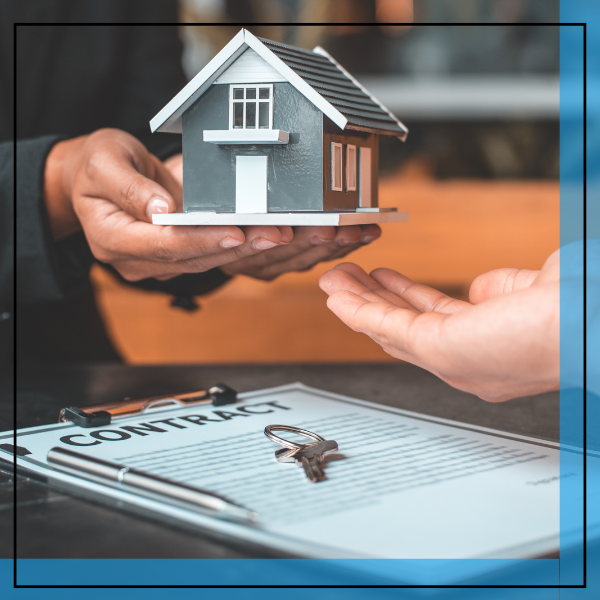 person handing over a model home. 