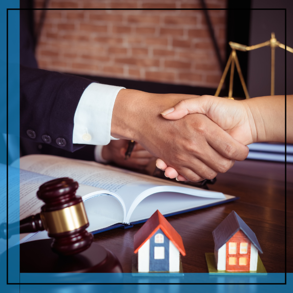 real estate attorney shaking hands with a client. 