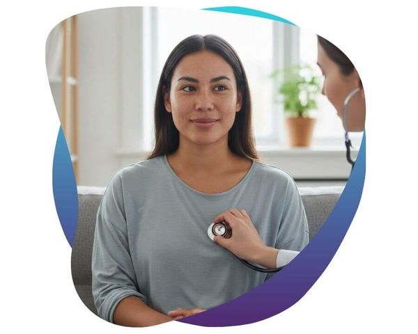 Healthcare provider using a stethoscope on a female patient.