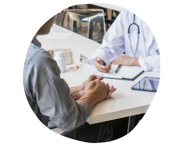 doctor taking notes with patient at table