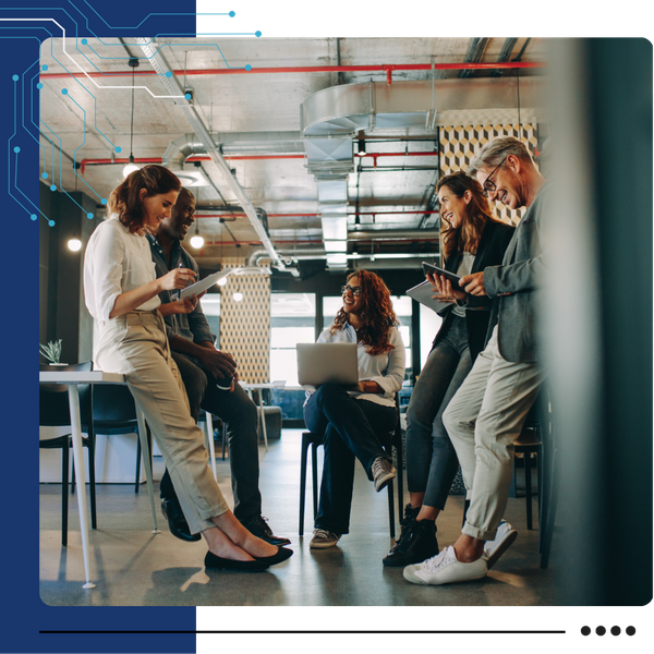 team members standing together and meeting