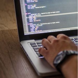 typing code on laptop