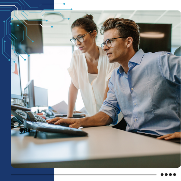 two professionals looking at computer