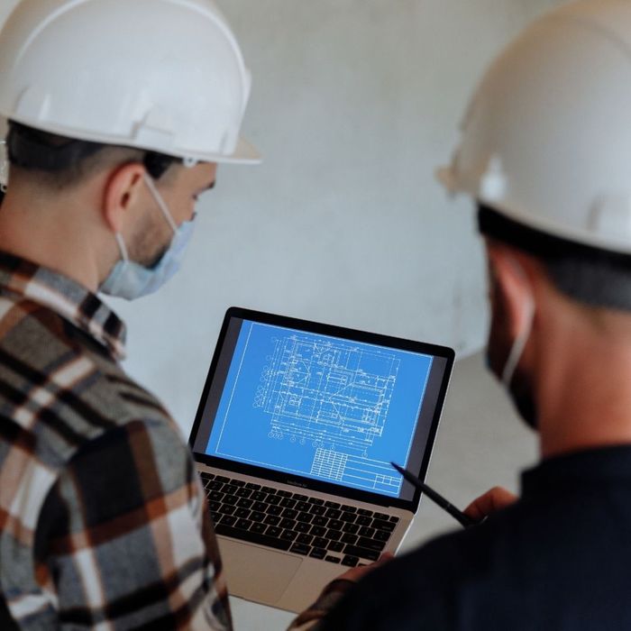 people looking at blueprints at a job