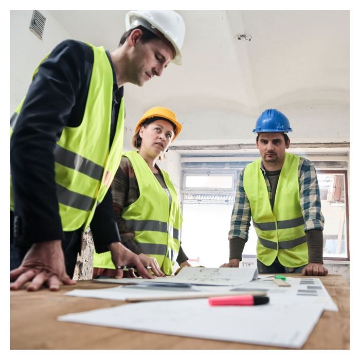 group of construction workers discussing plans