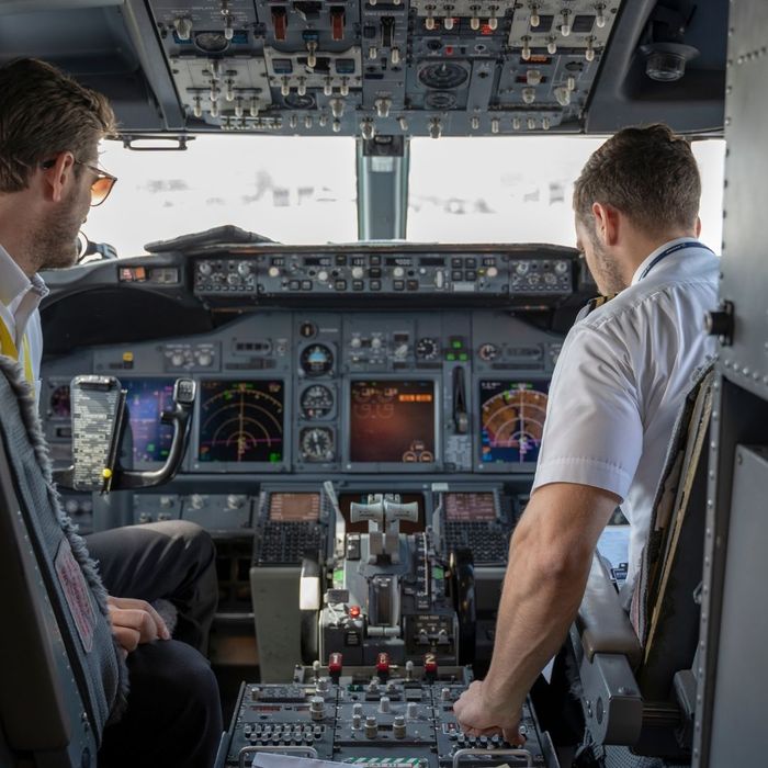 airplane pilots looking at navigation