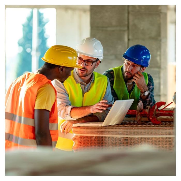 group of construction workers discussing plans