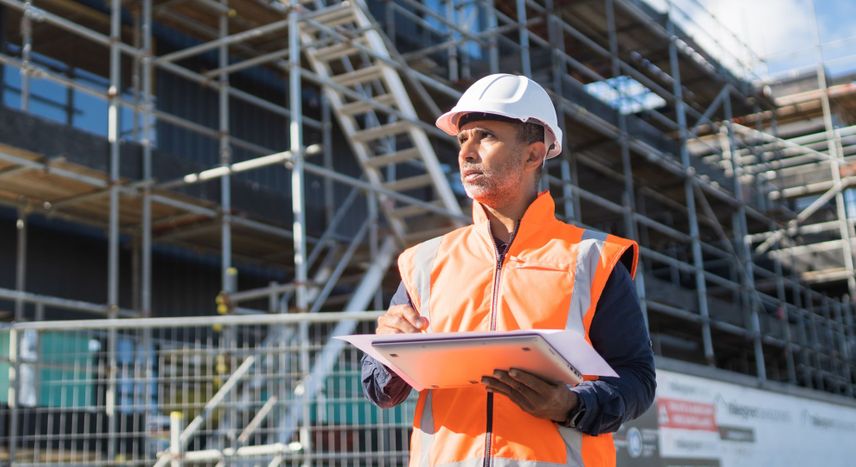 construction worker holding computer