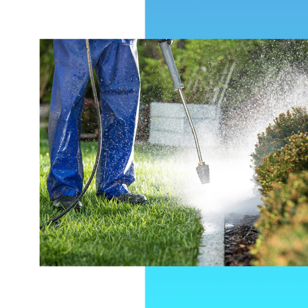 Person pressure washing an outdoor area