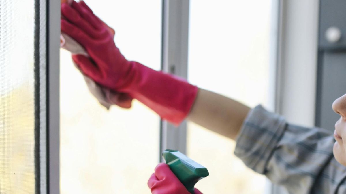 Person with gloves cleaning windows
