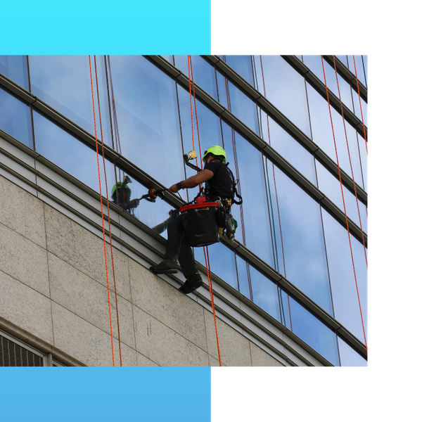 Person window cleaning a commercial building