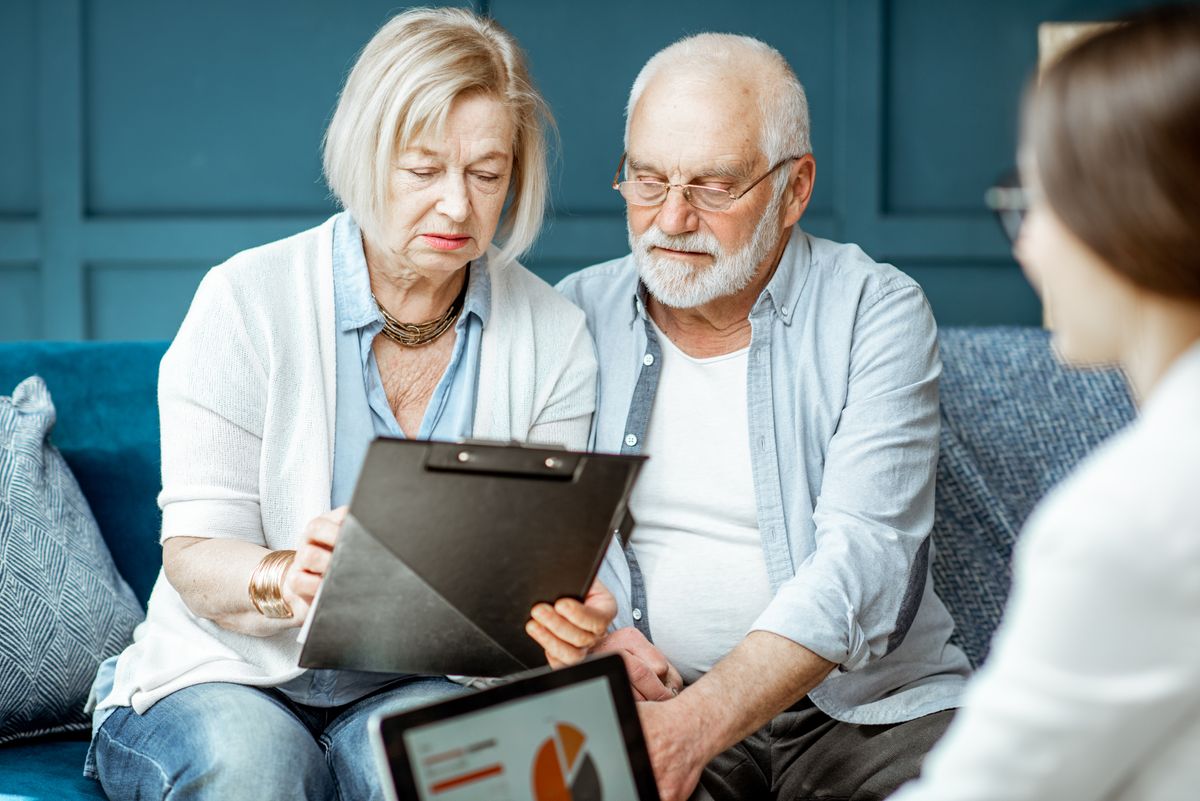 senior-couple-with-consultant-at-the-office-2022-01-19-00-03-28-utc.jpg