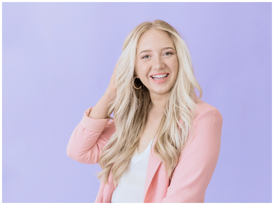 smiling woman with hand in her hair 
