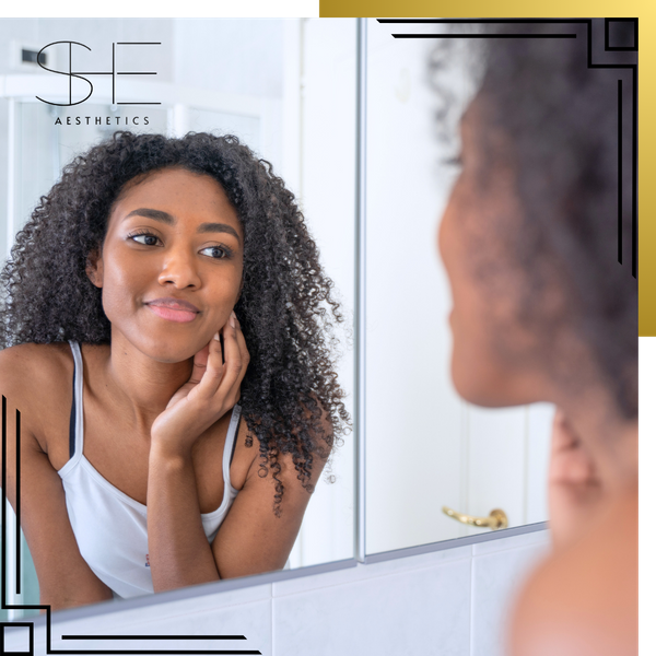 woman looking dissatisfied in mirror with sad eyes