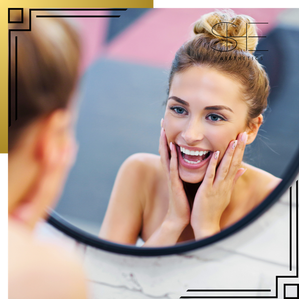 happy woman looking in mirror 