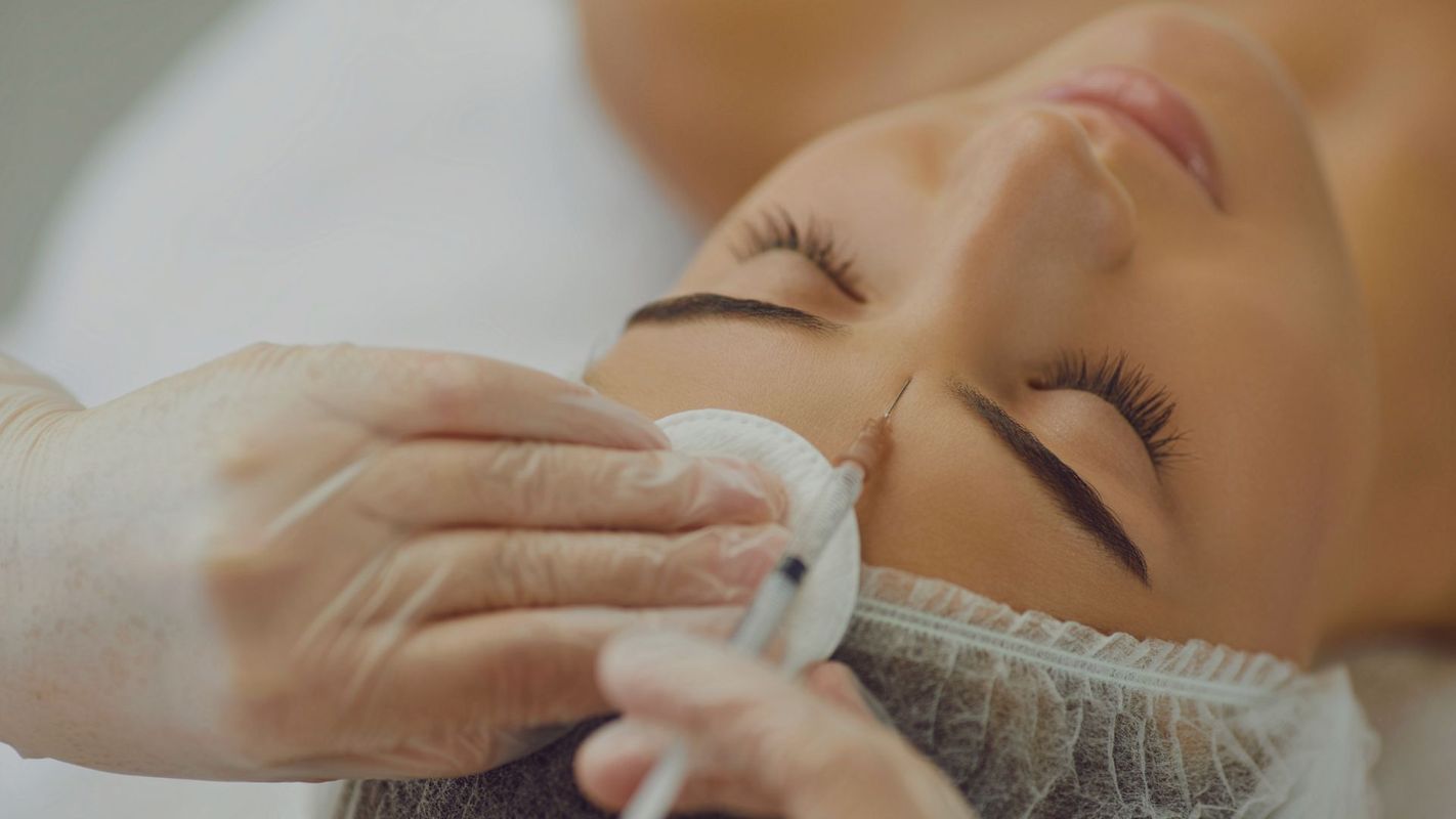 woman getting Botox injections in forehead