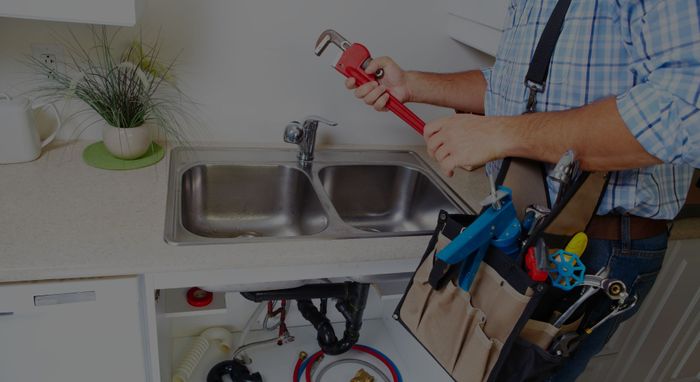 local plumber fixing a sink