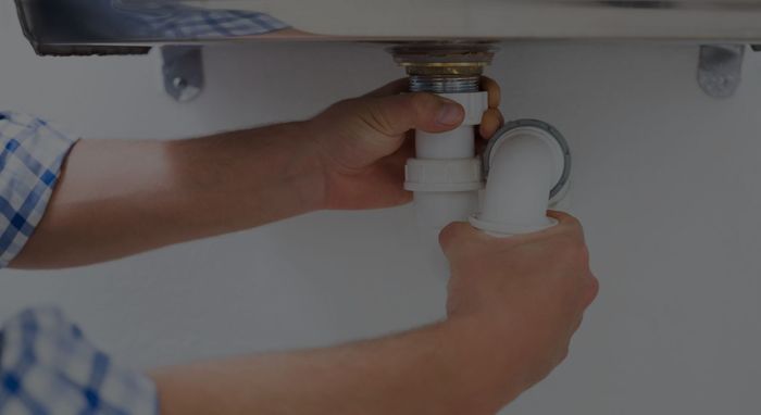 plumber working on a sink