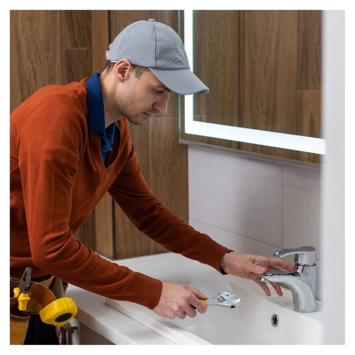 plumber fixing a faucet